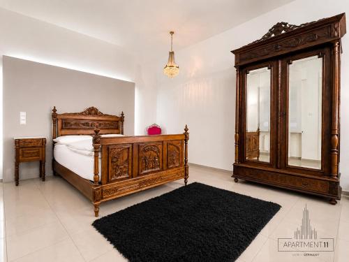 a bedroom with a large wooden bed and a mirror at apartment11 in Ulm