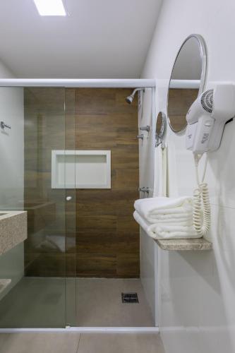 a bathroom with a shower and a sink and a mirror at Flat Central Arena Policia Federal in Brasília