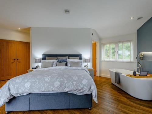 a bedroom with a large bed and a bath tub at 2 Bed in Weymouth oc-75201 in Weymouth