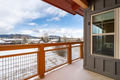 a balcony with a view of the snow covered mountains at Waterside West A206 in Fraser