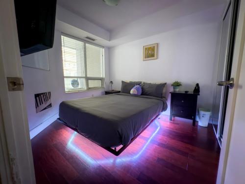 a bedroom with a bed with lights on the floor at Core Downtown Toronto-8 Sleeper-4 Beds-2 Bathrooms-Washrooms-Free Parking-CN Tower-Ripleys Museum-Blue Jays Stadium In front-Indoor Gym-Swimming Pool-Jacuzzi Sauna-Filter Drinking Water-WiFi in Toronto
