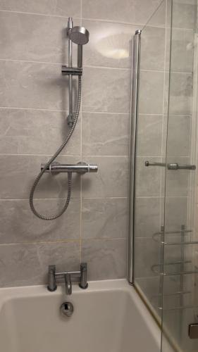 a shower in a bathroom with a bath tub at 40 kennett gardens in Gloucester