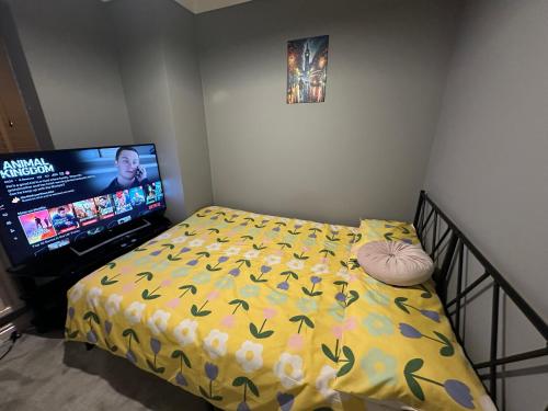 a bedroom with a bed and a flat screen tv at 40 kennett gardens in Gloucester