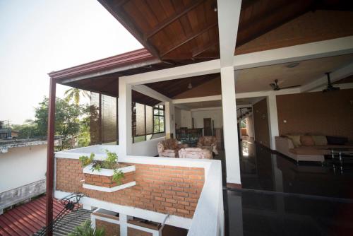 a balcony of a house with a brick wall at Melvila in Colombo