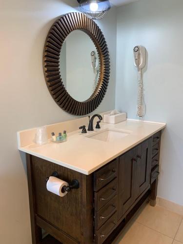 a bathroom with a sink and a mirror on the wall at Beachfront Condo in Simpson Bay, SXM - 2BR 2BA in Simpson Bay
