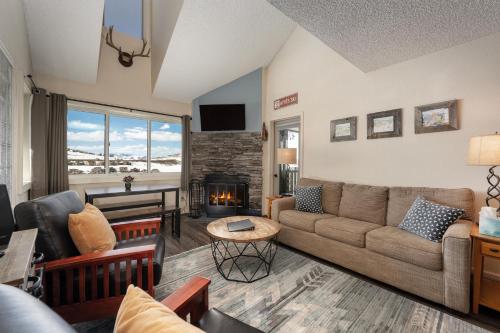 a living room with a couch and a fireplace at Summit Unit 1303 in Granby