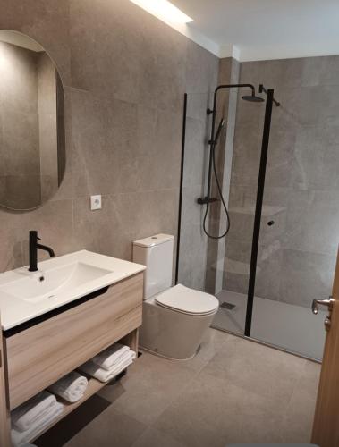 a bathroom with a sink toilet and a shower at Pensión O Novo in Treacastela