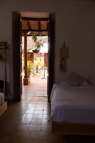 a bedroom with a bed and an open door at La Casona Espacio Bonito in Zapatoca
