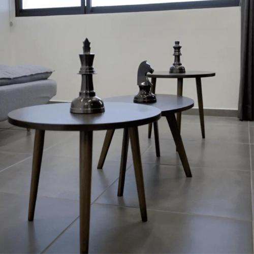 two tables with chessetts on them in a living room at Hotel Melanie Tepic in Tepic