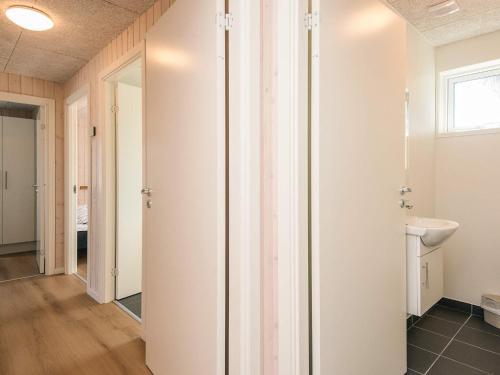 a bathroom with white walls and a sink at 5 star holiday home in Jerup in Jerup