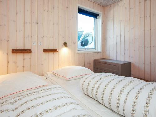 a bedroom with two twin beds and a window at 5 star holiday home in Jerup in Jerup