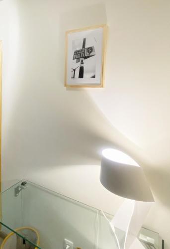 a white chair and a picture on a white wall at La loge in Marigot