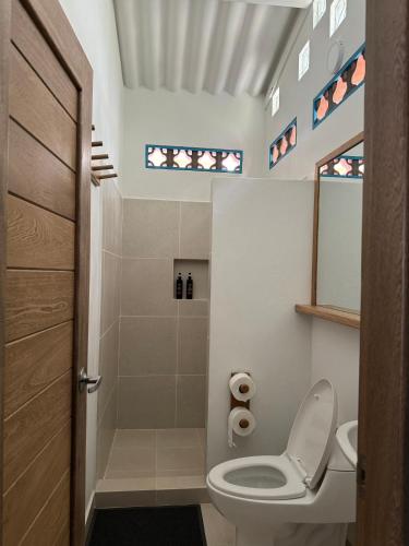 a bathroom with a toilet and a shower at Donde Andres en la Playa in Necoclí