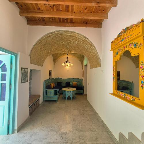 a hallway with an archway in a house at dar Beya in Kairouan