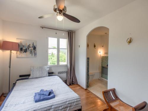 a bedroom with a bed and a ceiling fan at Belle vue in Flayosc