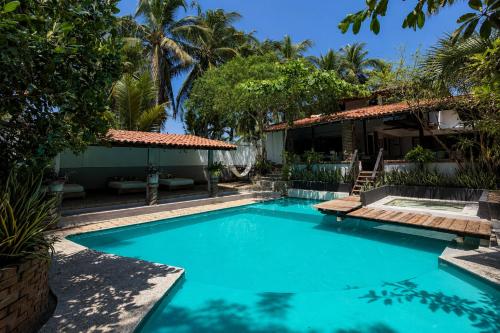 a swimming pool in front of a house at Hotel Verdemar in Acapulco