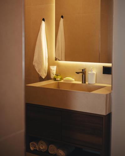 a bathroom with a sink and a mirror at A-Apartment in Gjakove