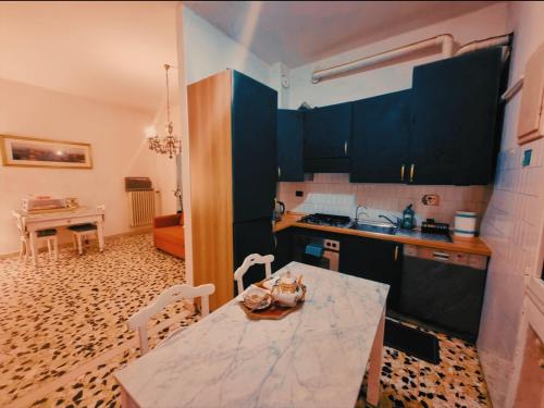 a kitchen with blue cabinets and a table with chairs at Bed and Break fast JIREH in Casalecchio di Reno