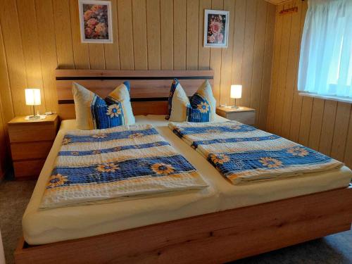 a bedroom with two beds with blue comforters at Holiday Home Uckeritz - Seebad 1 in Ueckeritz