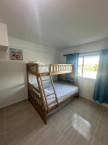 two bunk beds in a room with a window at Loft Apartment - Full AC With Free Parking Pool in Cartagena de Indias