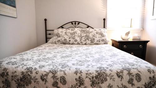 a bed with a blanket and a pillow on it at Lakeview Retreat in Cape May Point