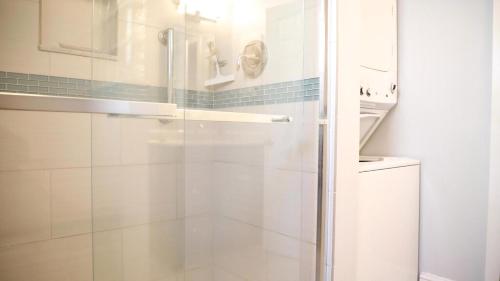 a shower with a glass door in a bathroom at Lakeview Retreat in Cape May Point