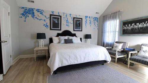 a bedroom with a large bed with blue wallpaper at West Cape Oasis in West Cape May