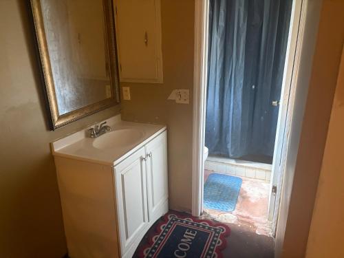 a bathroom with a sink and a mirror and a window at Pixie hollow single vacation retreat resort space in Orlando