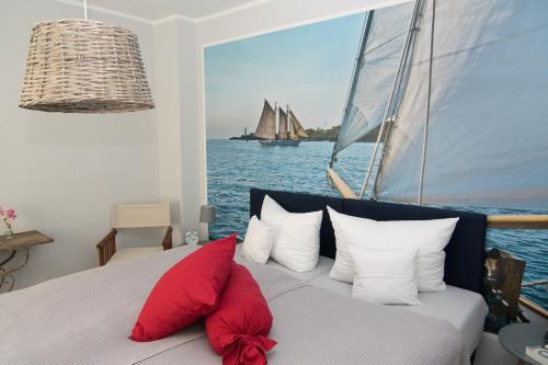 a bedroom with a bed with a sailboat on the water at Melkerhaus in Loit