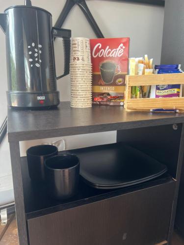 a kitchen counter with a sink and a coffee maker at Glamping oriente antioqueño in San Vicente