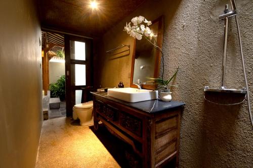 a bathroom with a sink and a mirror at The Villa Lululu in Tabanan
