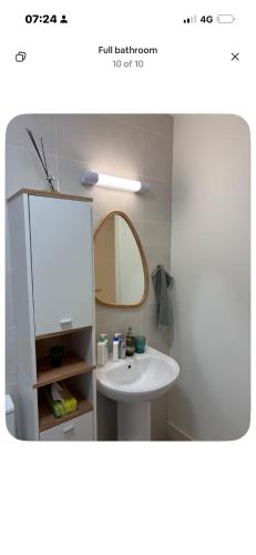 a bathroom with a white sink and a mirror at La Vio Homestay Private Room & Bathroom, Newcastle Dublin in Newcastle
