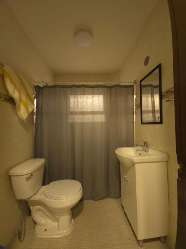 a bathroom with a toilet and a sink at Habitación en renta in Saltillo