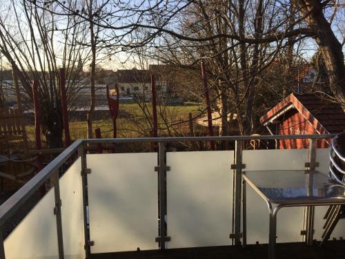 a table and a chair on a balcony at Hotel Restaurant Mühlenhof Bosse in Dachwig