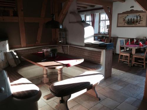 a restaurant with a table and chairs in a room at Hotel Restaurant Mühlenhof Bosse in Dachwig