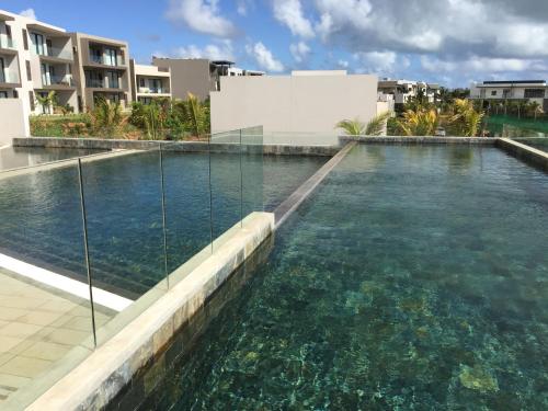 a swimming pool in the middle of a building at Azuri Appartements De Luxe in Roches Noires