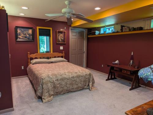 a bedroom with a bed and a ceiling fan at FIFA Basecamp with 2 Kitchens, 5BR, 4 Baths in Roeland Park