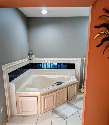 a large bath tub in a room with at FIFA Basecamp with 2 Kitchens, 5BR, 4 Baths in Roeland Park