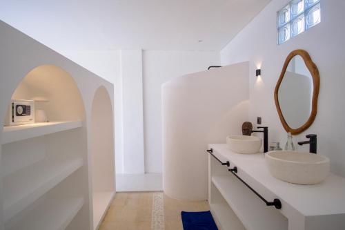 a white bathroom with a sink and a mirror at NEW! 2BR Ocean View, Infinity Pool, Villa Kerylos in Sampalan