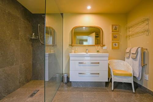 a bathroom with a sink and a shower at Ballymoney Cnoc in Tai Tapu