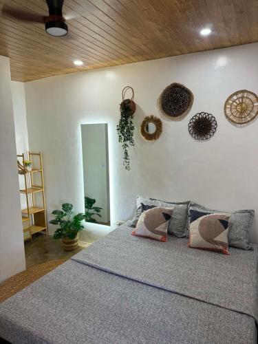 a bedroom with a large bed and a mirror at Villa Luyo in General Luna
