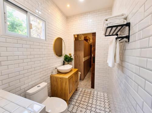 a white bathroom with a sink and a toilet at Villa Vista in Wok Tum