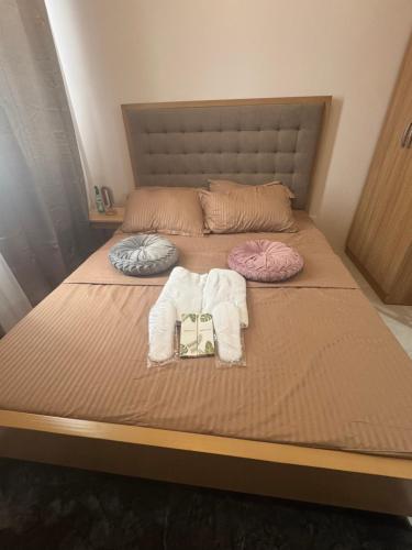 a bed with two towels and a purse on it at Staycation Hub in Mandaue City