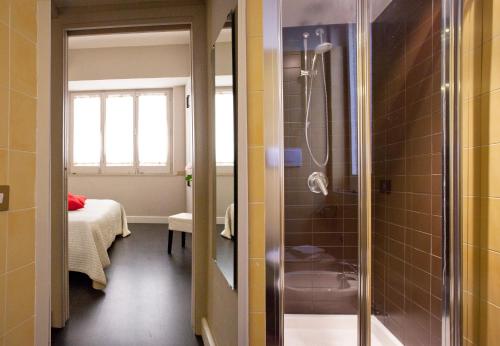 a bathroom with a shower and a room with a bed at Sorrento Apartments One in Sorrento