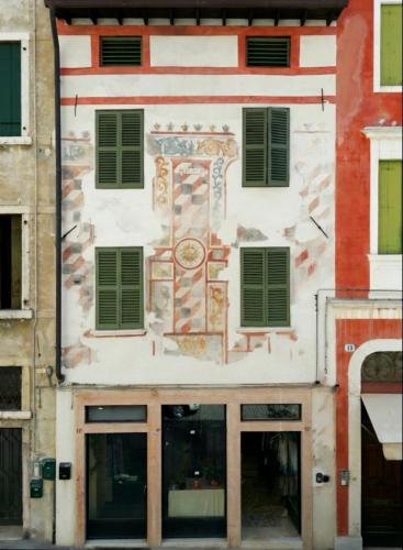 a building with a painting on the side of it at Marinali Rooms - 1460 in Bassano del Grappa