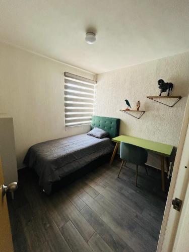 a bedroom with a bed and a desk and a table at Camino antiguo a Tesistan in Zapopan