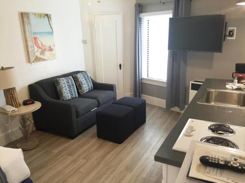 a small living room with a couch and a kitchen at Capitola Venetian Vacation Rentals in Capitola
