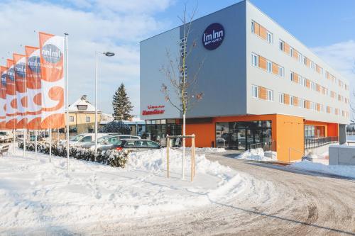 a building with a lot of snow in front of it at I´m Inn Wieselburg in Wieselburg