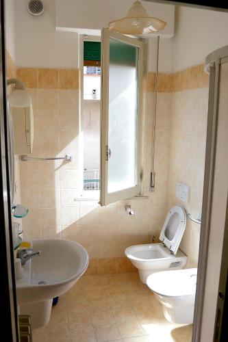a bathroom with a toilet and a tub and a sink at Appartamenti In Residence Zoe in Roseto degli Abruzzi