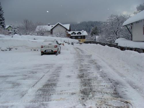 a car driving down a snow covered road at Drei Tannen in Bodenmais